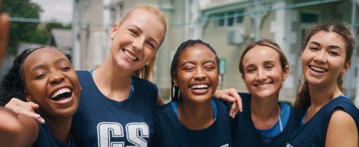 A group of college athletes smiling for a photo