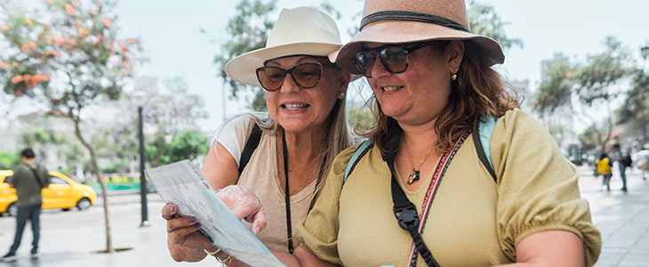 Two tourists consult a map on a walking tour