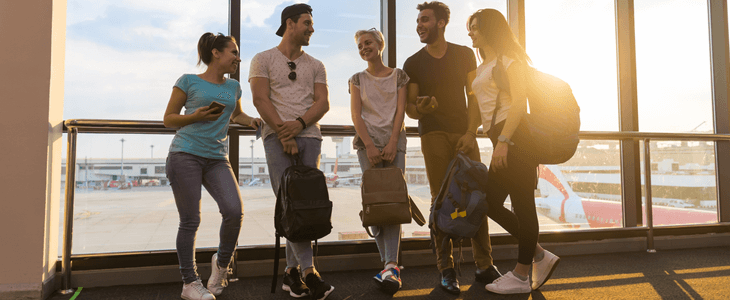 a group of people stand at an airport