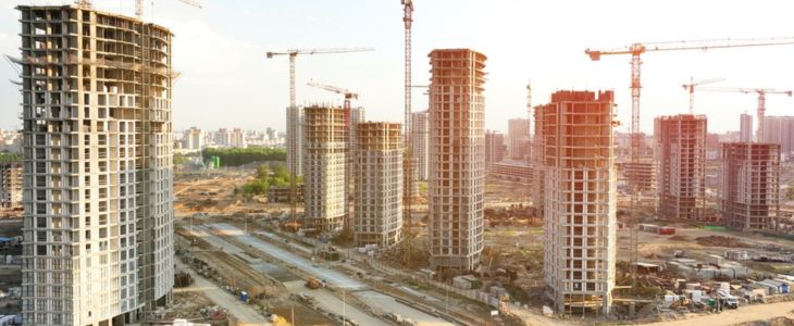 aerial view of a large and expansive construction building project with skyscrapers and towers