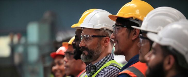 a profile view of a group of construction workers wearing hardhats