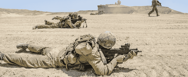 A soldier reloading a weapon during a training exercise.