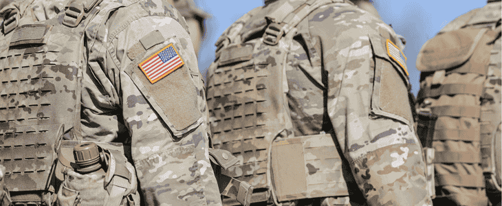 A line-up of soldiers saluting.