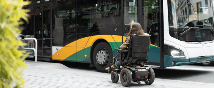 a person in a wheelchair waits to enter a bus