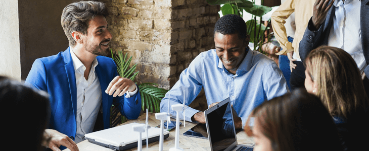 a group of corporate people talking and laughing