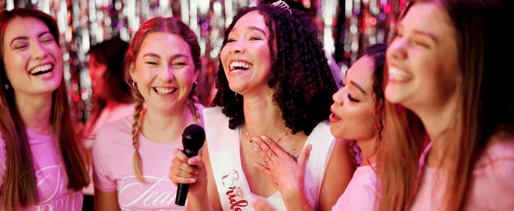 a group of women smiling at a bachelorette party